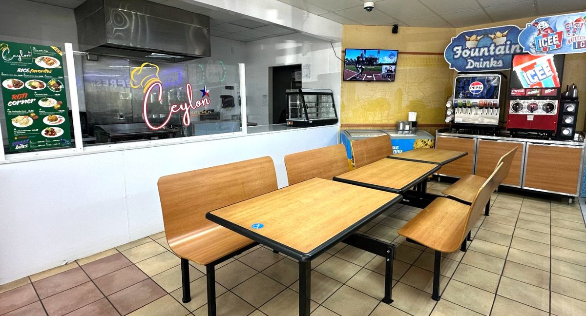 Ceylon Kitchen dining area inside the gas station — neon sign and booths